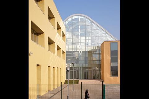 Simple concrete structures hold the classrooms, linked by the ETFE atriums